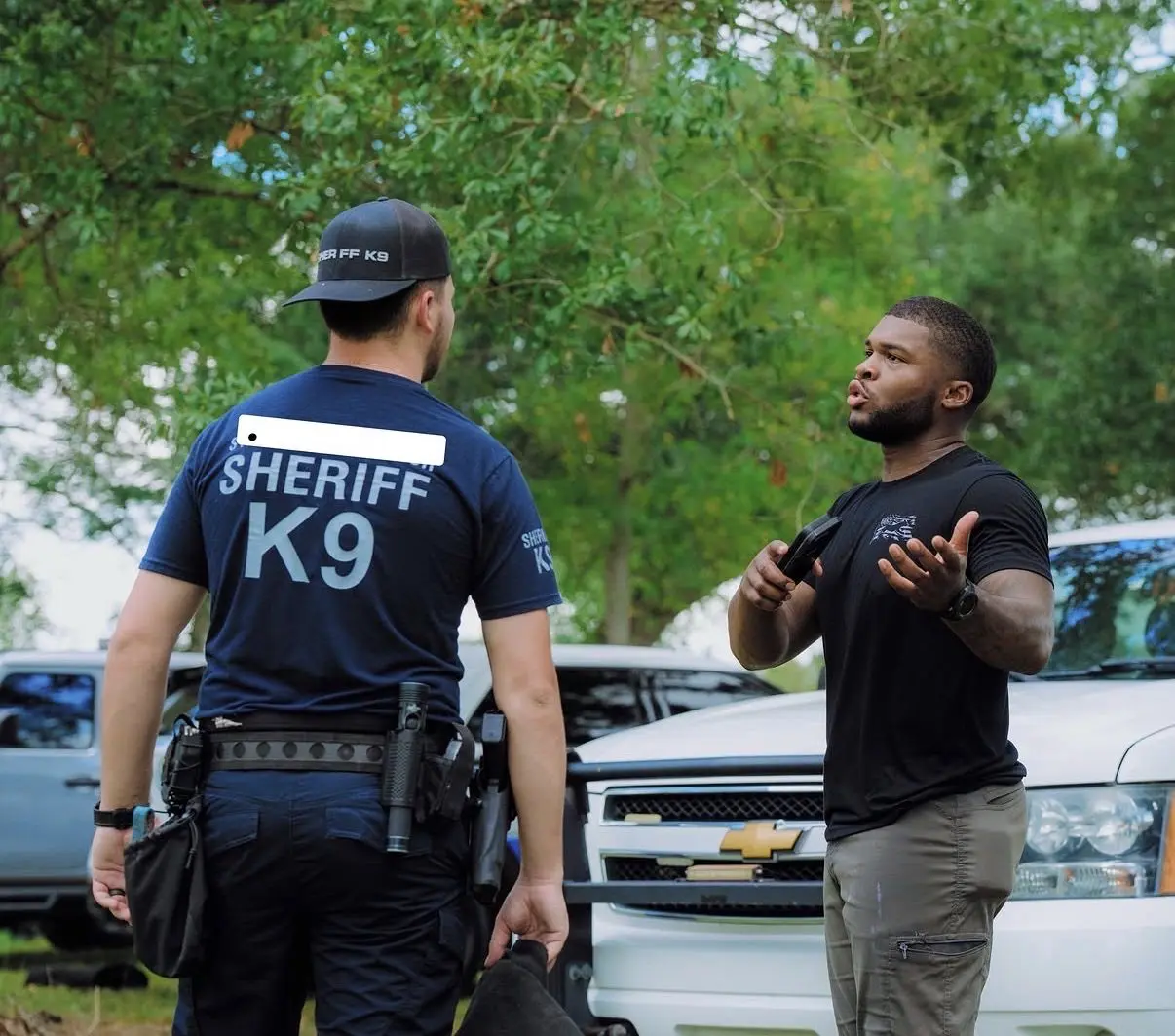 Walter Bell talking with a sheriff K9 handler