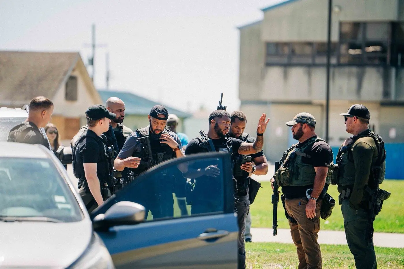 Walter Bell briefing his tactical team beside a vehicle
